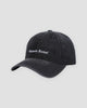 Black washed denim baseball cap with white Pamela Raina lettering on the front