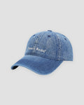 Dark blue washed denim baseball cap with white Pamela Raina lettering on the front