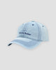 Light blue washed denim baseball cap with navy Pamela Raina lettering on the front
