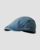 Medium blue washed denim flat cap, side view with the metal slider strap