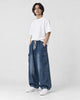 Model wearing the blue cargo jeans, three-quarter view of the thigh pocket