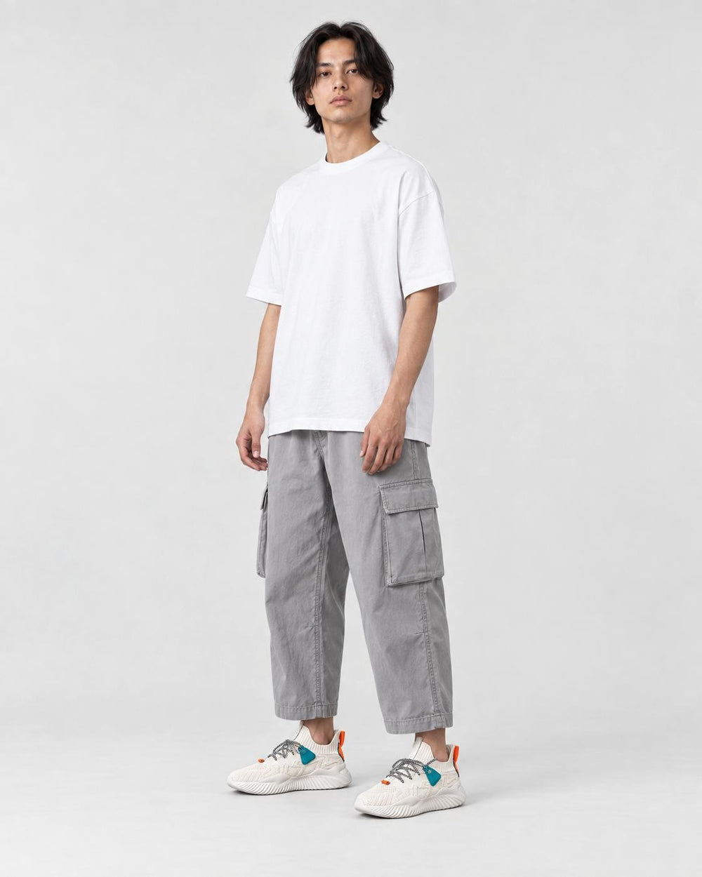Model wearing the beige knit sock sneakers, three-quarter view