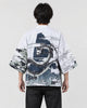 Man seen from behind in the white haori with a coiling gray dragon and black and white waves on the back, over a black tee