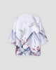 White haori jacket on a hanger, back view with gray mountains, white cranes and red plum blossoms along the hem