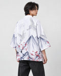 Man in the white haori seen from behind at an angle, with gray mountains, white cranes and red plum blossoms, black tee