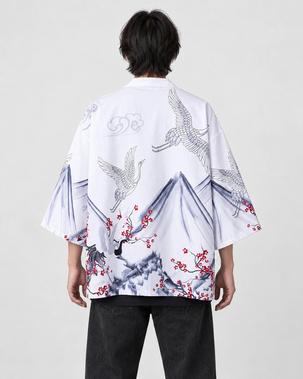 Man seen from behind in the white haori with gray ink mountains, white cranes and red plum blossoms, over a black tee