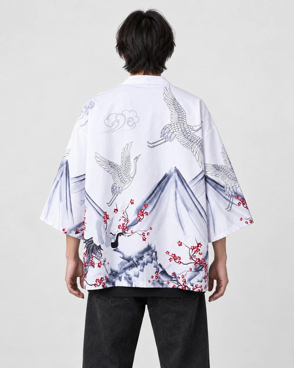 Man seen from behind in the white haori with gray ink mountains, white cranes and red plum blossoms, over a black tee