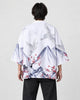 Man seen from behind in the white haori with gray ink mountains, white cranes and red plum blossoms, over a black tee