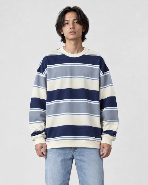 Model wearing the blue-gray striped crewneck sweatshirt with light-wash jeans, front view