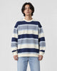 Model wearing the blue-gray striped crewneck sweatshirt with light-wash jeans, front view