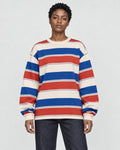 Model wearing the red striped crewneck sweatshirt with dark jeans, front view