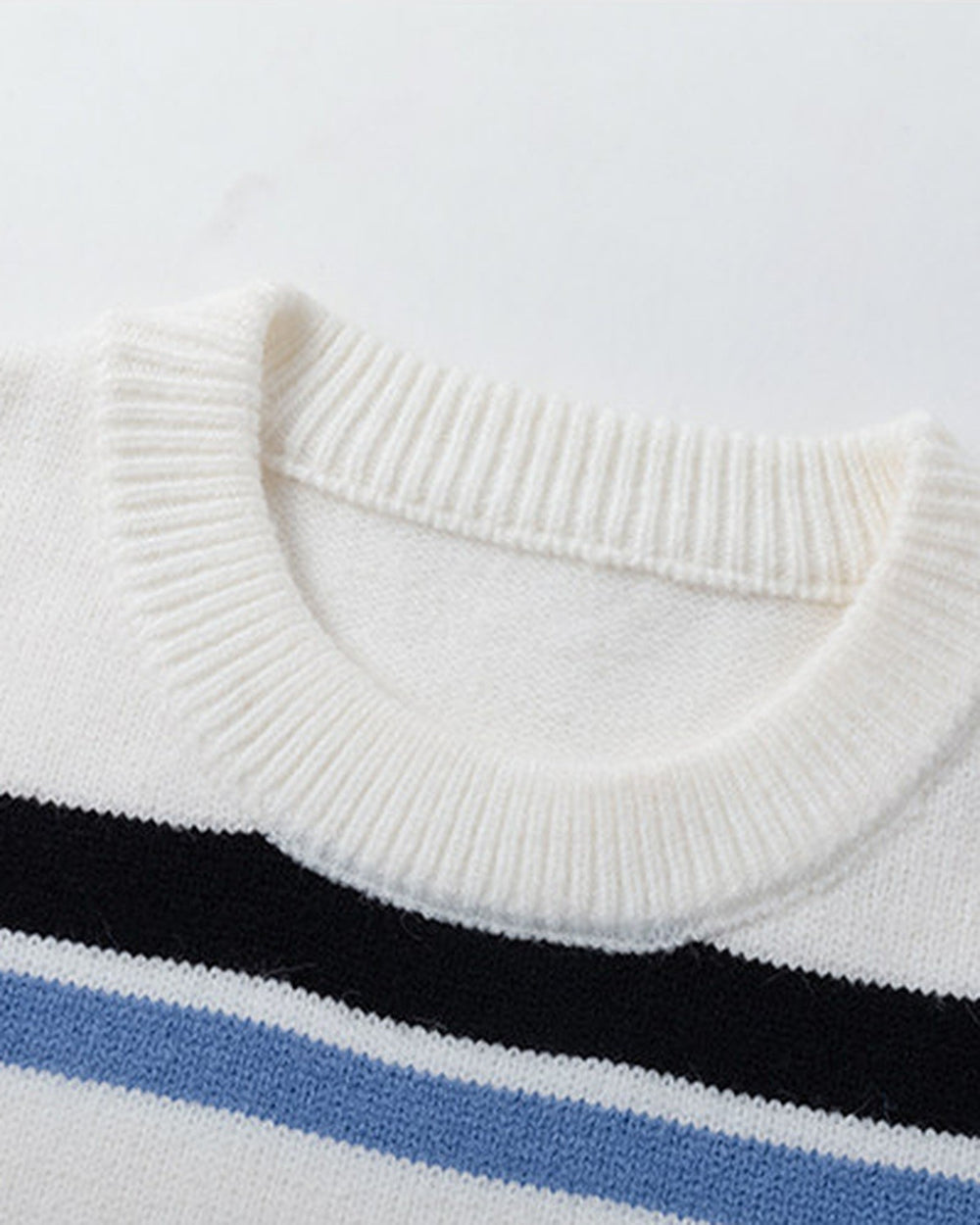 Close-up of the ribbed crew neck and the first black and blue stripes