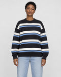 Model wearing the black striped knit sweater with light-wash jeans, front view