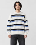 Model wearing the white striped knit sweater with dark jeans, front view