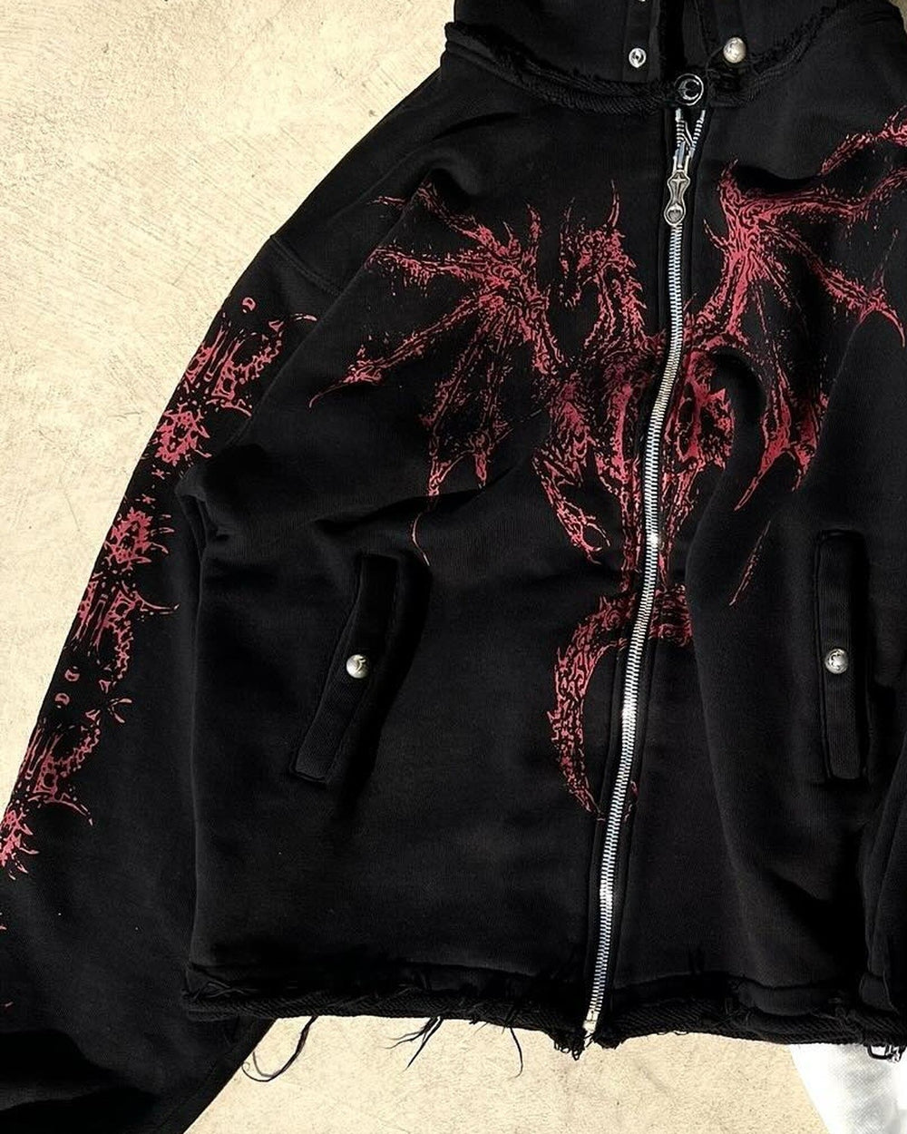 Close-up of the red winged dragon graphic and the zipper on the black hoodie