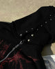 Close-up of the silver studs along the hood of the black hoodie