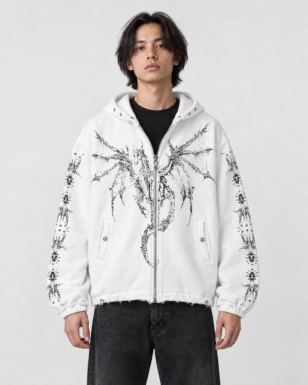 Model wearing the white winged dragon zip hoodie over a black tee, front view
