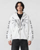 Model wearing the white winged dragon zip hoodie over a black tee, front view