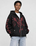 Model wearing the black zip hoodie with a red winged dragon graphic, three-quarter view