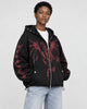 Model wearing the black zip hoodie with a red winged dragon graphic, three-quarter view