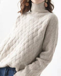 Three-quarter view of the beige sweater showing the diagonal basket-weave texture across the body and sleeve