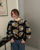 Woman standing in the black flower-patch jacket with a phone in her hand