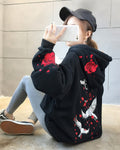 Black loose hoodie, back view with embroidered white cranes and roses