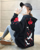 Black loose hoodie, back view with embroidered white cranes and roses