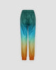 Back of the gradient jogger pants laid flat, with an elastic waistband and orange gathered cuffs