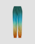 Gradient jogger pants laid flat, dark teal at the waist fading through cream to orange at the elastic cuffs
