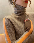 Brown and cream herringbone turtleneck with an orange stripe down the sleeve, torso view