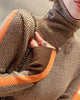 Herringbone turtleneck shoulder with the orange sleeve stripe and a chain strap