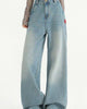 Washed high-waisted wide-leg jeans in light blue, front view of the fade from waist to hem