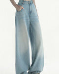 Light-blue wide-leg jeans with one hand in the pocket, showing the straight wide leg to the floor