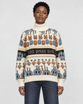 Model wearing the cream jacquard knit sweater with bunny and smiley face rows and a black lettering band, with dark jeans