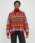 Model wearing the red jacquard knit sweater with bunny and smiley face rows and a brown lettering band, with black jeans