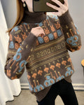 Coffee brown jacquard knit sweater with orange and blue bunny and smiley faces and a lettering band