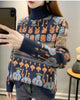 Navy high-neck jacquard knit sweater, three-quarter view, showing the faces, mushroom trees and blue figures