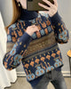 Navy jacquard knit sweater with rows of bunny and smiley faces, a brown lettering band and a ribbed roll neck