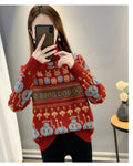 Red high-neck jacquard knit sweater, front view, with mushroom trees and large blue figures above the hem