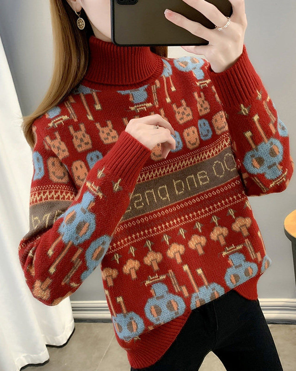 Red jacquard knit sweater with rows of bunny and smiley faces, a brown lettering band and a ribbed roll neck