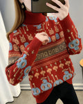 Red jacquard knit sweater with rows of bunny and smiley faces, a brown lettering band and a ribbed roll neck