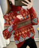 Red jacquard knit sweater with rows of bunny and smiley faces, a brown lettering band and a ribbed roll neck