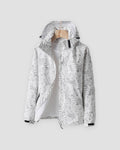 White leaf-print hooded windbreaker with gray leaf shapes, a black collar tab and hook-and-loop cuffs, on a hanger