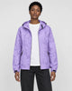 Model wearing the light purple leaf-print hooded windbreaker open over a white tee and black jeans, front view