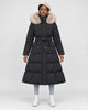 Model wearing the black long puffer coat with a khaki fluffy hood trim and a tie belt, front view