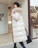 White long puffer coat with a khaki fluffy hood trim, a belt and wide channel quilting, worn with a black bag