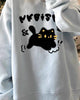 Light blue loose sweatshirt with a black cat print, worn loose, front view