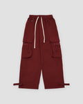 Maroon red wide-leg cargo pants laid flat with thigh flap pockets, a cream drawcord and ankle straps