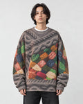Model wearing the yarn patchwork cable print sweater with black jeans, front view